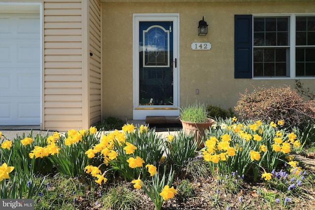 142 Faust Cir, Bellefonte, PA 16823 - doorway to property featuring a garage and stucco siding