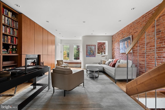 1910 Biltmore St NW Unit 2, Washington, DC 20009 - living area featuring wood finished floors, brick wall, built in features, and a lit fireplace