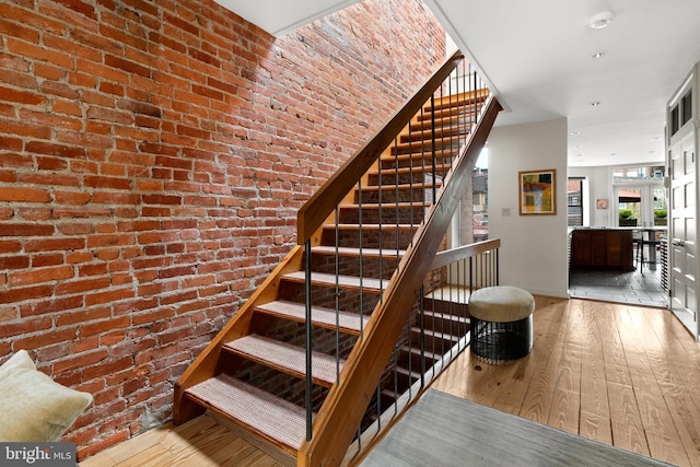 1910 Biltmore St NW Unit 2, Washington, DC 20009 - stairs featuring hardwood / wood-style floors, brick wall, and recessed lighting
