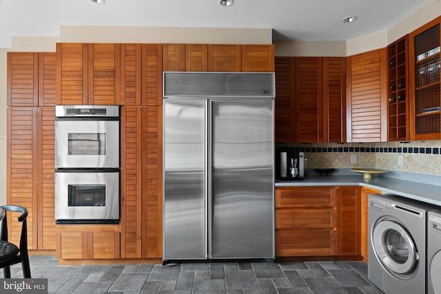 1910 Biltmore St NW Unit 2, Washington, DC 20009 - kitchen featuring appliances with stainless steel finishes, washer / dryer, glass insert cabinets, backsplash, and recessed lighting