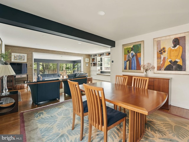 dining room with baseboards, recessed lighting, beamed ceiling, and wood finished floors