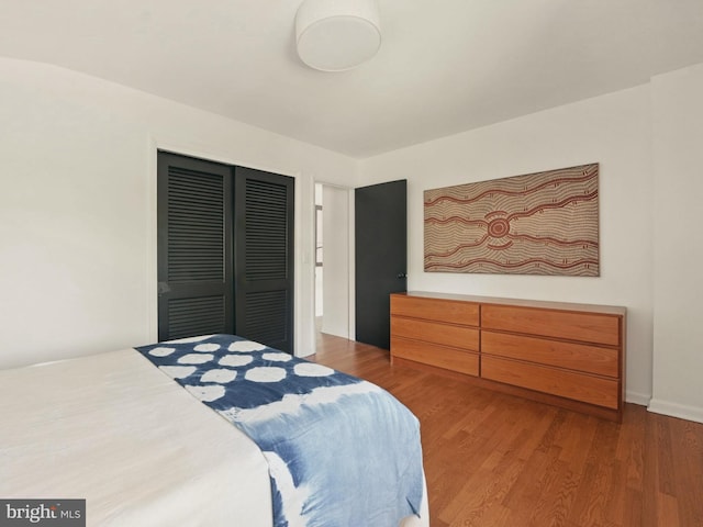 bedroom featuring a closet and wood finished floors