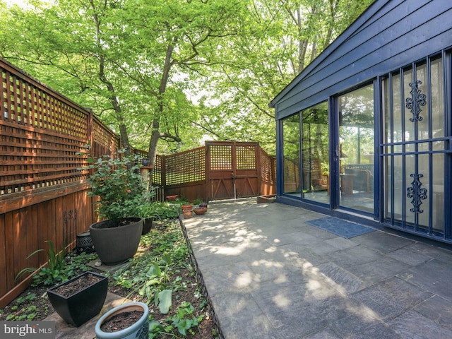 view of patio / terrace featuring fence and a gate