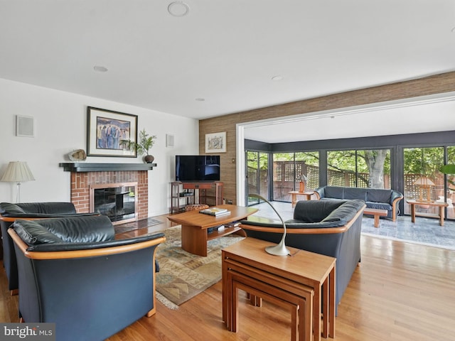 living area featuring light wood-style floors and a fireplace