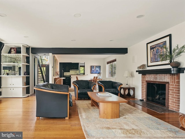 living room with recessed lighting, light wood-style flooring, and a fireplace