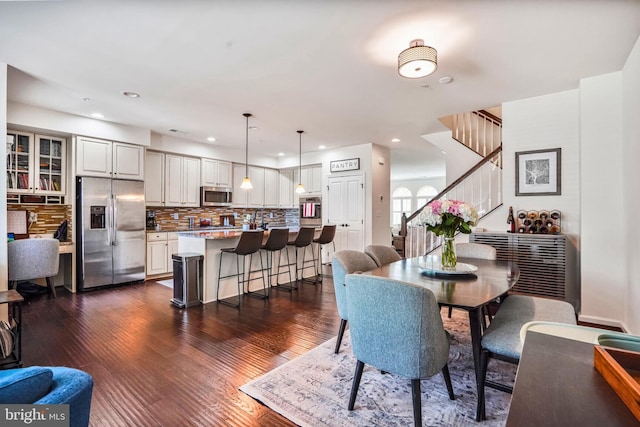 dining space with stairs, recessed lighting, and dark wood-style flooring