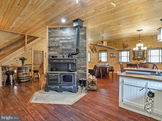 125 Rural Retreat Ln, Great Cacapon, WV 25422 - living room with a wood stove, wooden walls, wood ceiling, wood-type flooring, and healthy amount of natural light