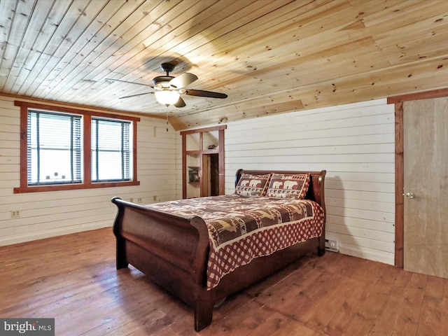 125 Rural Retreat Ln, Great Cacapon, WV 25422 - bedroom with wood ceiling, wood-type flooring, wood walls, vaulted ceiling, and a ceiling fan