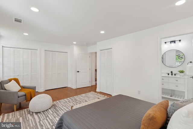 bedroom featuring recessed lighting, two closets, and visible vents