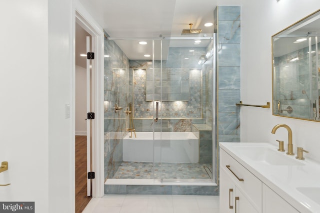bathroom with recessed lighting, tile patterned floors, double vanity, a sink, and a stall shower