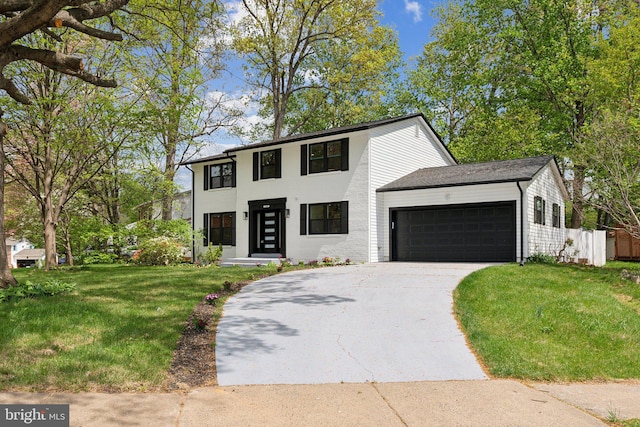 view of front facade with a garage, driveway, a front lawn, and fence