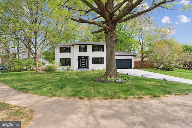 view of front of property with concrete driveway, a front lawn, and stucco siding