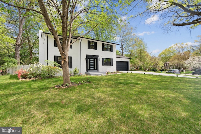 view of front facade featuring fence, a front lawn, stucco siding, an attached garage, and concrete driveway