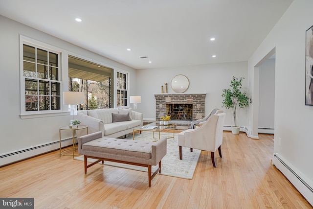 living area featuring recessed lighting, light wood finished floors, and a baseboard radiator