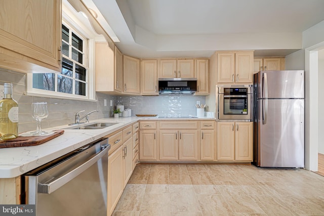 kitchen featuring a sink, light brown cabinetry, and stainless steel appliances