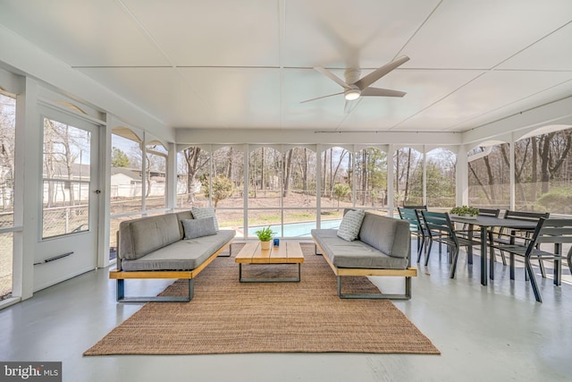 sunroom / solarium with outdoor lounge area, finished concrete floors, and a ceiling fan