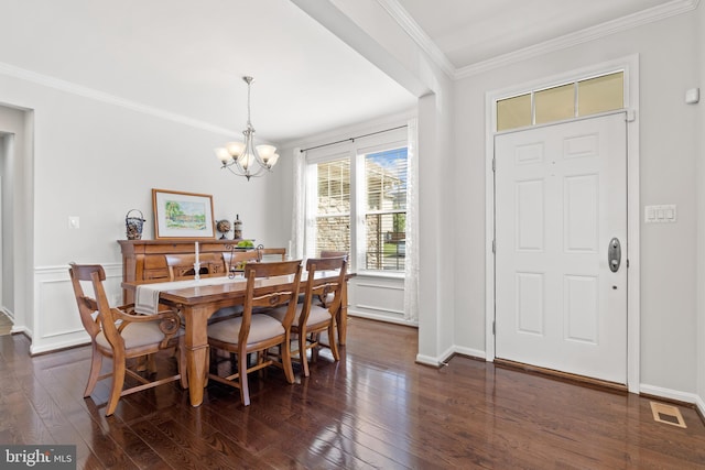 42364 Winsbury W Pl, Sterling, VA 20166 - dining area featuring dark wood-style flooring, a chandelier, crown molding, wainscoting, and baseboards
