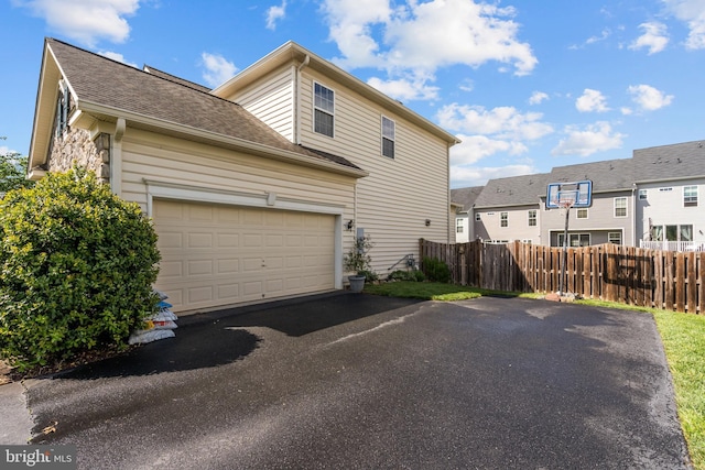 42364 Winsbury W Pl, Sterling, VA 20166 - view of side of property with fence, driveway, a garage, and a shingled roof