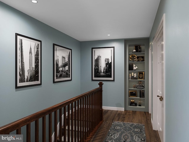 hallway with recessed lighting, baseboards, built in features, and wood finished floors