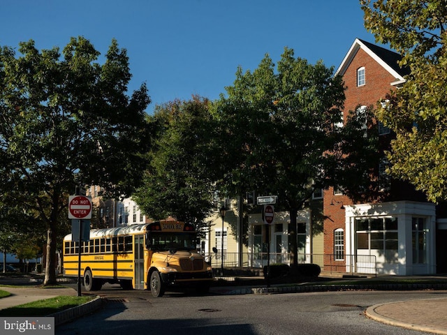 exterior space featuring traffic signs, sidewalks, and curbs
