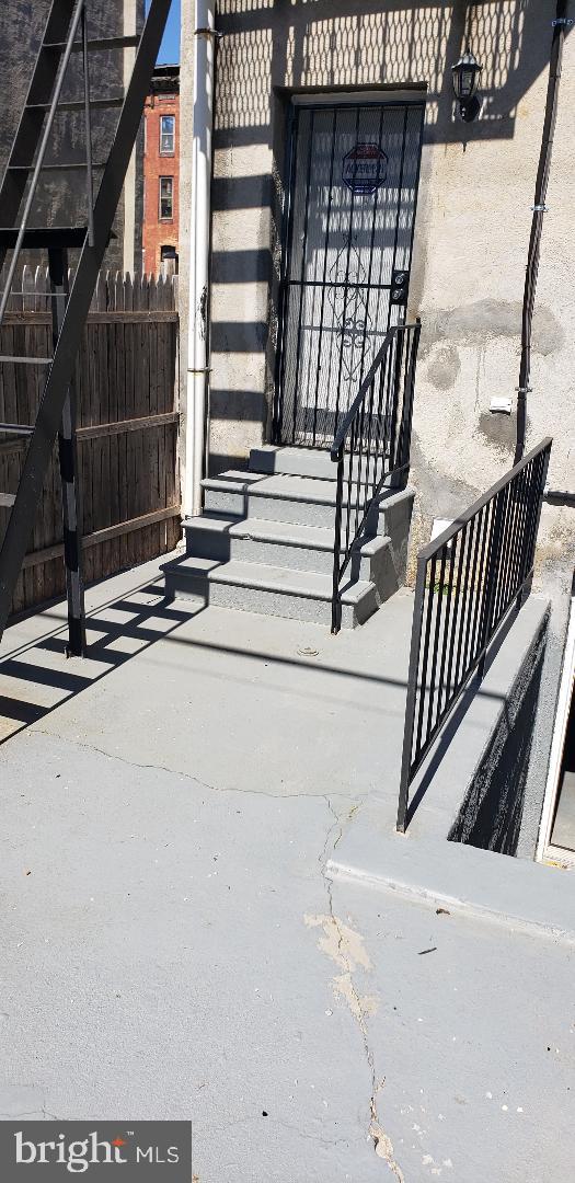 view of exterior entry with fence