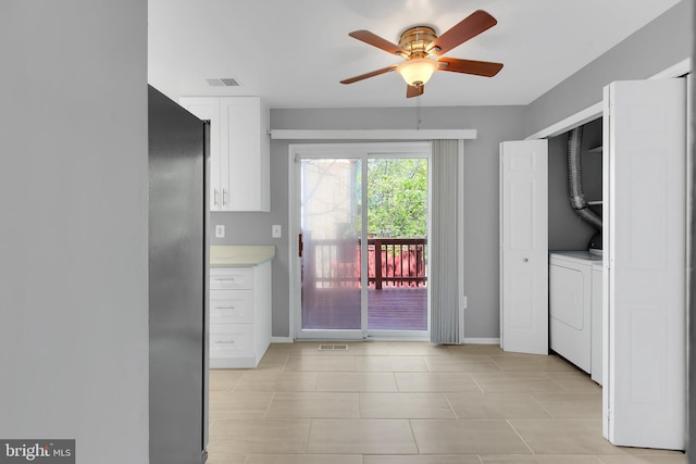 laundry room featuring laundry area, visible vents, baseboards, a ceiling fan, and light tile patterned floors