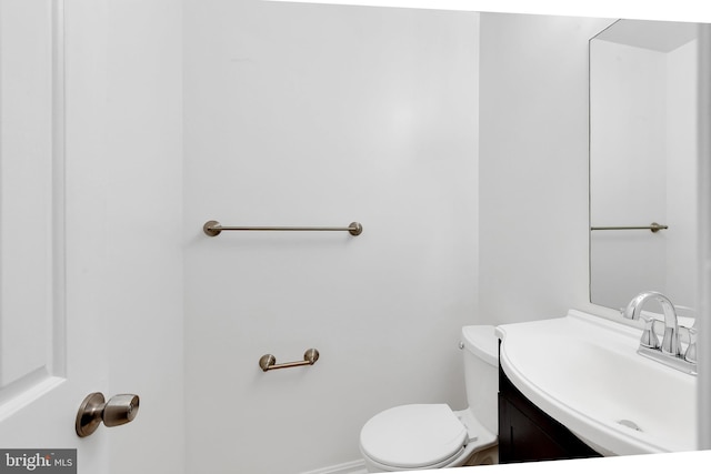 bathroom featuring toilet and vanity