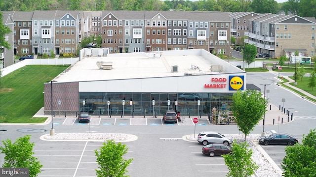 view of building exterior featuring uncovered parking