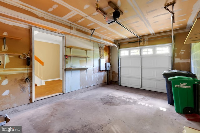 garage with a garage door opener and electric panel
