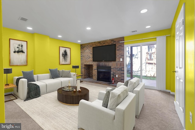 living area with recessed lighting, a brick fireplace, carpet flooring, and visible vents