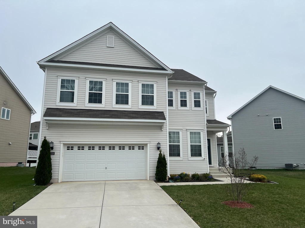 traditional home featuring concrete driveway, cooling unit, a front yard, and a garage
