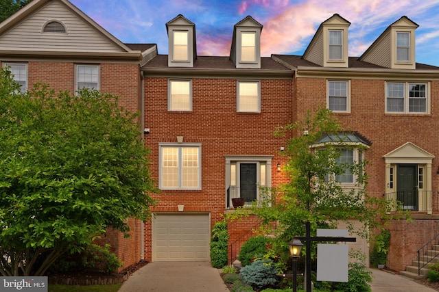 12015 Johns Pl, Fairfax, VA 22033 - view of property with an attached garage, driveway, and brick siding