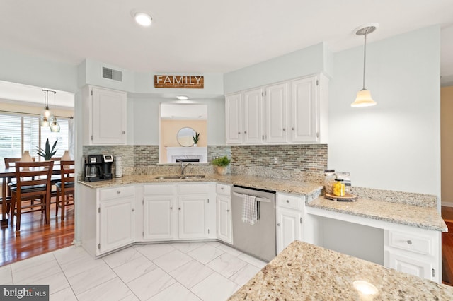 12015 Johns Pl, Fairfax, VA 22033 - kitchen with dishwasher, a sink, white cabinetry, decorative light fixtures, and decorative backsplash