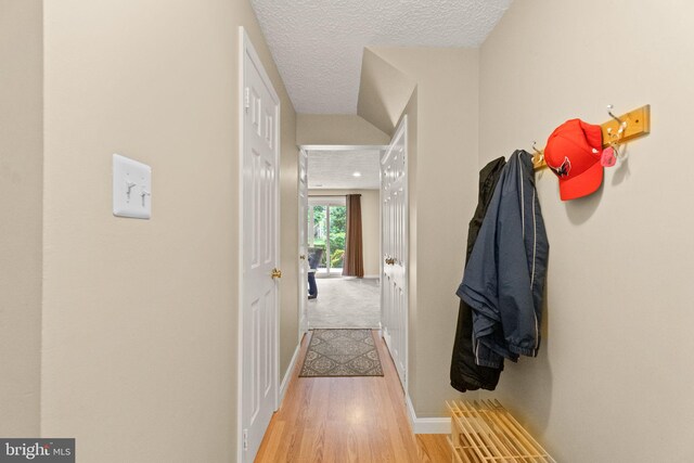 12015 Johns Pl, Fairfax, VA 22033 - corridor with baseboards, light wood-style flooring, and a textured ceiling