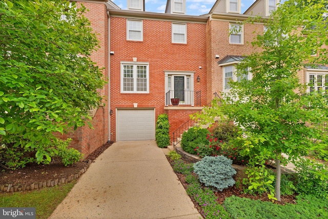 12015 Johns Pl, Fairfax, VA 22033 - view of property featuring concrete driveway, an attached garage, and brick siding