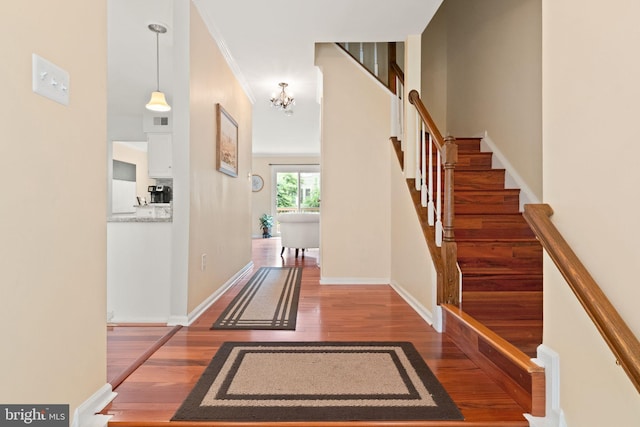 12015 Johns Pl, Fairfax, VA 22033 - entrance foyer featuring wood finished floors, stairs, a chandelier, baseboards, and ornamental molding