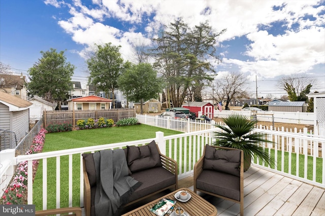 wooden terrace featuring a yard, a residential view, outdoor lounge area, and a fenced backyard