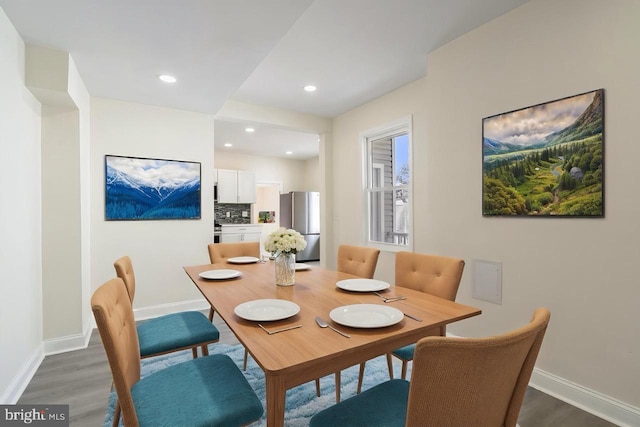 dining area with recessed lighting, baseboards, and wood finished floors