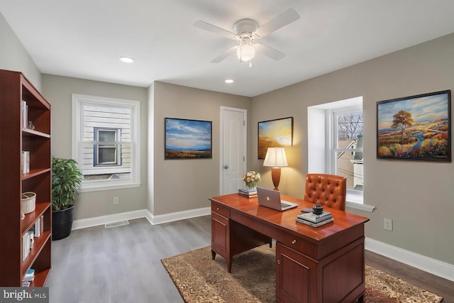 home office featuring dark wood-type flooring, a ceiling fan, visible vents, recessed lighting, and baseboards