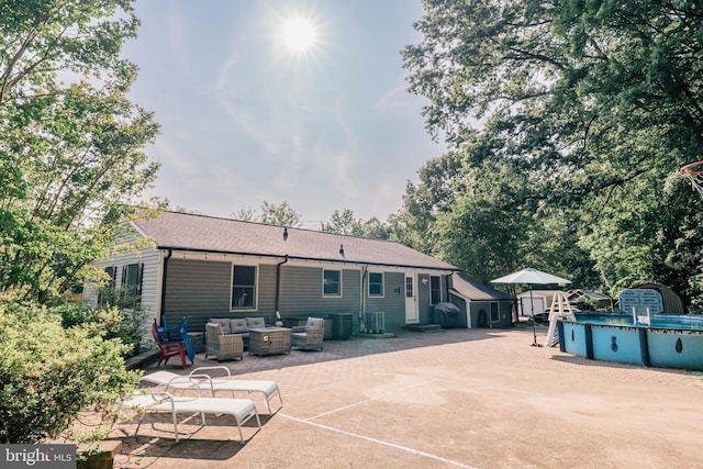 97 Winding Creek Rd, Stafford, VA 22554 - rear view of property featuring a patio, outdoor lounge area, an outdoor pool, roof with shingles, and cooling unit