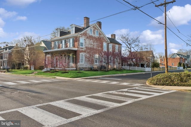 view of street with a residential view, sidewalks, and curbs