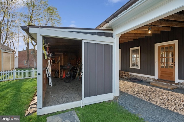 view of outbuilding featuring fence