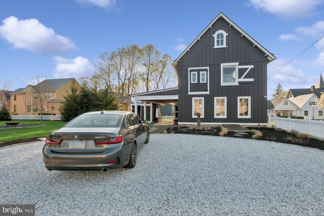modern farmhouse with board and batten siding and fence