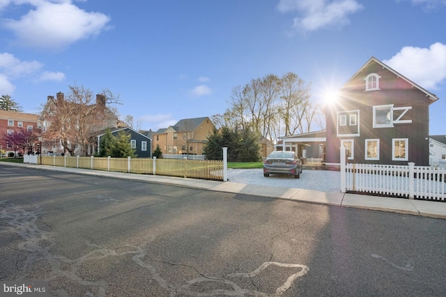 view of front of home featuring a residential view and a fenced front yard