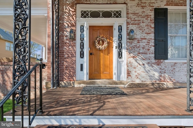 view of exterior entry with brick siding
