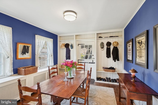 dining room with crown molding and wood finished floors