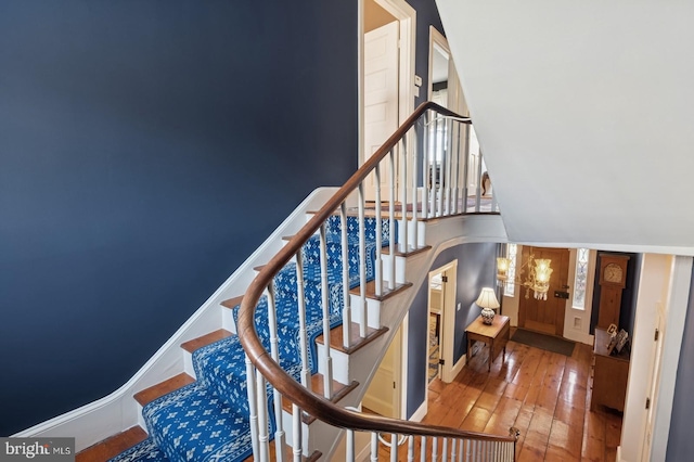 staircase with baseboards and hardwood / wood-style flooring