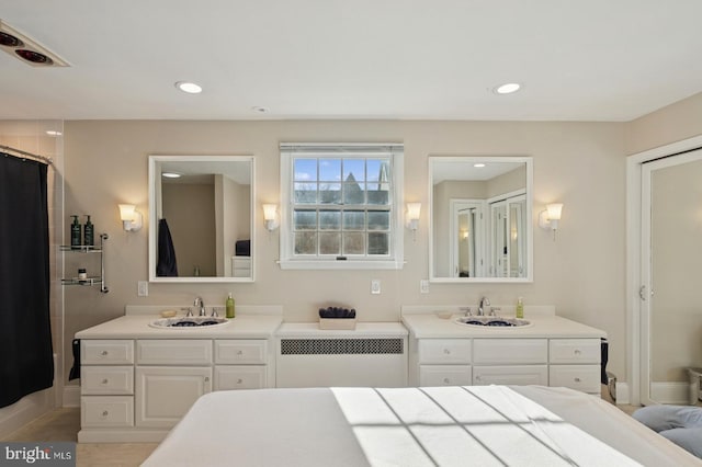 full bath featuring radiator, vanity, recessed lighting, and a shower with shower curtain