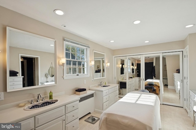 bedroom with recessed lighting, a sink, french doors, and radiator