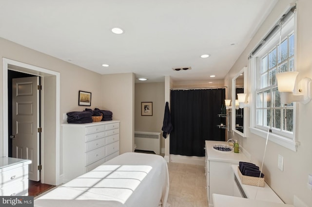 bedroom featuring radiator and recessed lighting